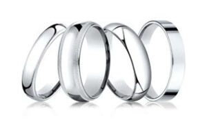 A group of five silver rings displayed on a white background. Each ring has a simple, sleek design, with slight variations in width and edges. Some rings have rounded edges, while others have a flat or slightly beveled finish.