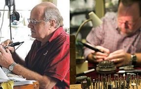 Two middle-aged men work with engraving tools. The man on the left wears a red shirt and glasses, focusing intently on his work. The man on the right, also wearing glasses and a checkered shirt, is engrossed in his task, surrounded by various tools and equipment.