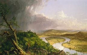 A river winds through a lush, green valley under a dramatic sky with dark storm clouds on the left and clear skies on the right. Dense forest covers the left hillside, while patches of sunlight illuminate the open fields and hills in the distance.