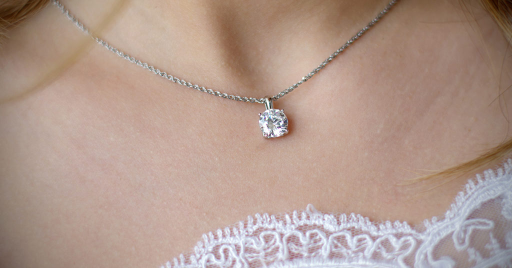 a woman accessorizing a simple diamond necklace with lace fringe