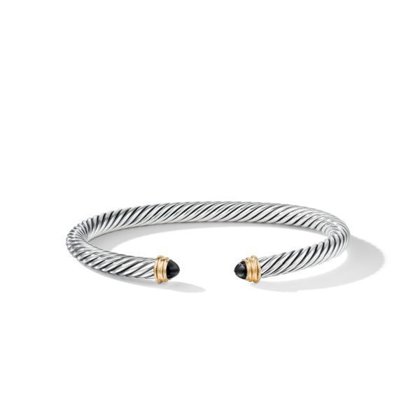 A silver twisted cable bracelet with open ends, each tipped with a black onyx stone encased in a gold setting, isolated on a white background.