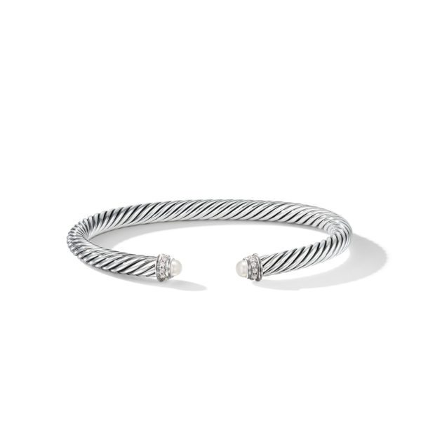 A silver cuff bracelet with a twisted rope design, featuring two pearl-like end caps each accented with small, clear stones. The open-ended design creates a gap in the center of the bracelet. The piece is placed on a white background with a slight shadow.