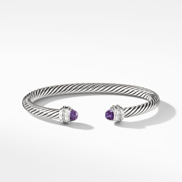 A silver twisted cable bracelet featuring two round purple gemstone caps at the open ends, accented with small clear stones. The bracelet is elegantly displayed against a plain white background.