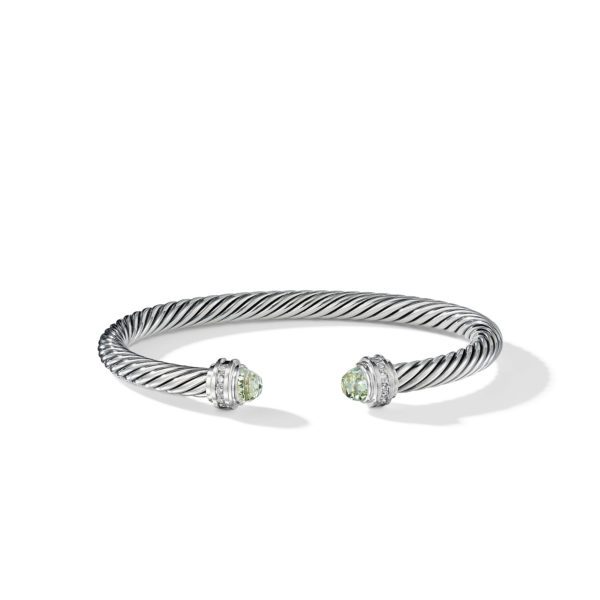 A silver twisted cable bracelet with open ends, each adorned with round green gemstone caps and small diamond accents. The bracelet's texture features a twisted rope design.