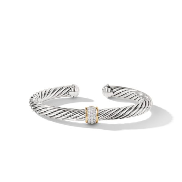 A silver twisted cable bangle bracelet featuring a central cylindrical element adorned with small diamonds and accented with gold bands on either side. The bracelet is open at the back and has a sleek, elegant design.