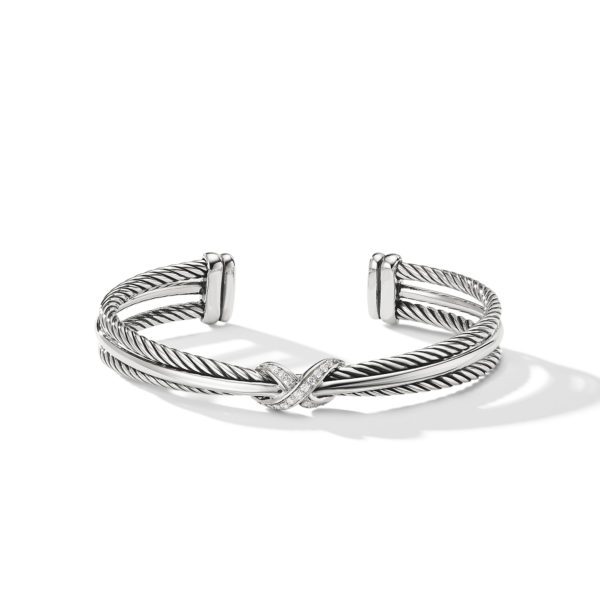 A silver cuff bracelet with a twisted rope design and open ends. The bracelet features a crossover detail with small embedded stones at the front center. The piece casts a subtle shadow on a white background.