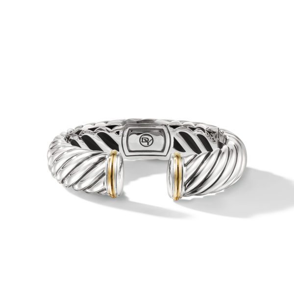 A silver bangle bracelet featuring a twisted rope design with open ends, accented by round, gold-toned caps. The inner side of the bracelet displays a small, engraved icon. The bracelet is set against a white background with a soft shadow cast below it.