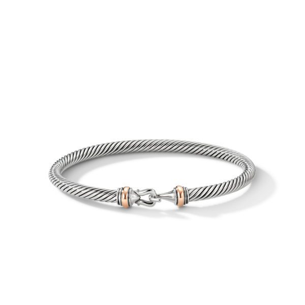 A silver twisted cable bracelet featuring a polished hook clasp with rose gold accents on either side. The bracelet is elegantly designed and has a sleek, sophisticated appearance. The clasp is detailed and stands out prominently against the twisted cable texture.