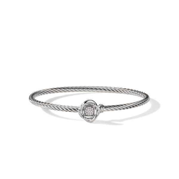 A sleek silver bracelet with a twisted rope design features a central ornament adorned with sparkling diamonds. The bracelet is set against a plain white background, casting a subtle shadow.