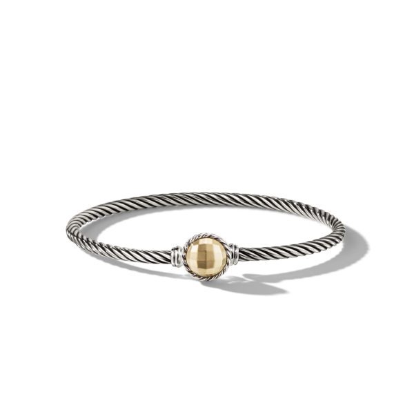 A silver twisted rope bracelet with a round golden gemstone at the center. The gemstone is held in place by a matching twisted silver setting. The bracelet casts a slight shadow on a white background.