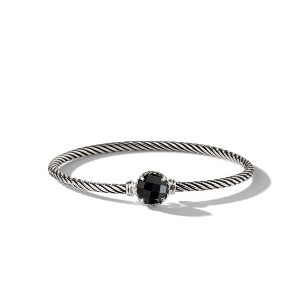 A silver twisted cable bracelet with a black faceted gemstone centerpiece, casting a small shadow on a white background. The bracelet has two small silver accents on either side of the gemstone.