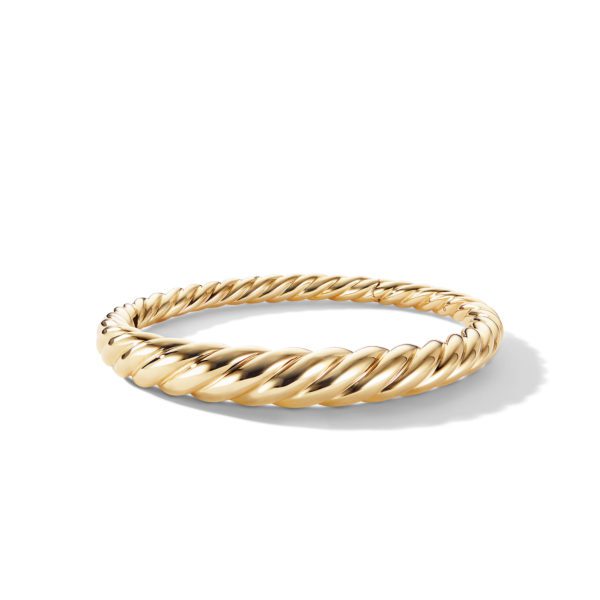 A gold bangle featuring a twisted rope design, placed on a plain white background with a subtle shadow underneath.