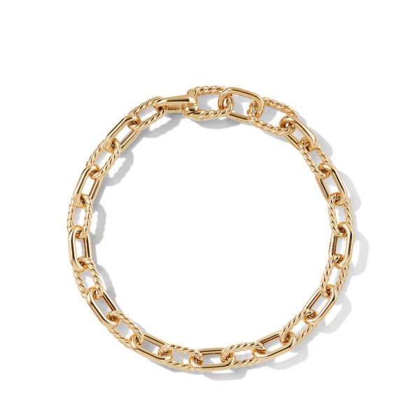 A close-up image of a gold chain bracelet with large, twisted links arranged in an elegant circular shape. The bracelet is placed on a white background, casting a soft shadow.