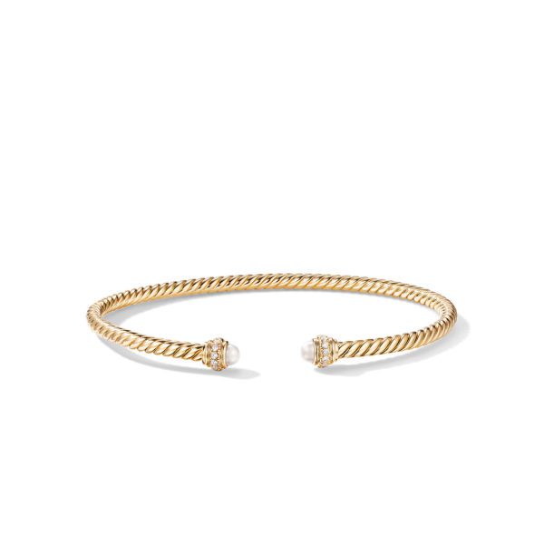 A gold twisted rope bracelet with open ends, each adorned with a pearl and surrounded by small, sparkling gemstones. The bracelet is simple yet elegant, designed for the wrist.