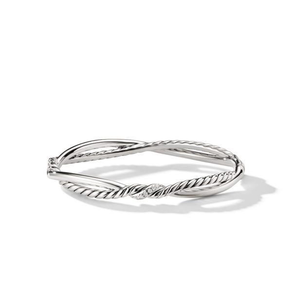 A sleek, twisted silver bracelet featuring a rope-like design. It has two intertwining bands that create an elegant, minimalist aesthetic. The bracelet's polished finish gleams against a plain white background, highlighting its intricate details.