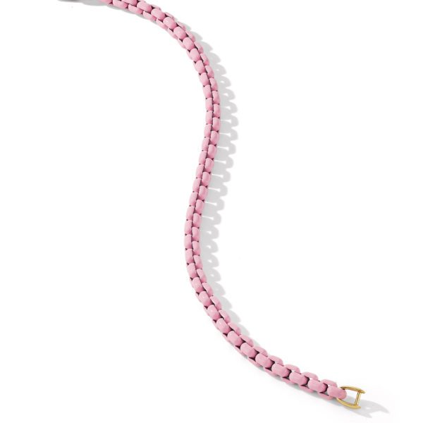 A pink braided strap with a small gold buckle on one end, laid out in a curved, wave-like formation on a white background. The strap casts a soft shadow to the left, adding dimension to its appearance.