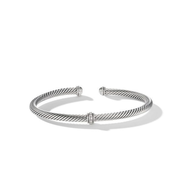 A silver twisted rope cuff bracelet with an open design and two small rectangular embellishments at the ends facing inward. The bracelet has a sleek, polished finish and casts a light shadow on a white background.