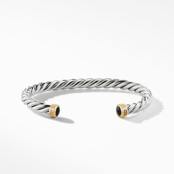 A stylish cuff bracelet with a twisted silver band and two gold end caps, each adorned with a round black stone. The bracelet is displayed on a white background.