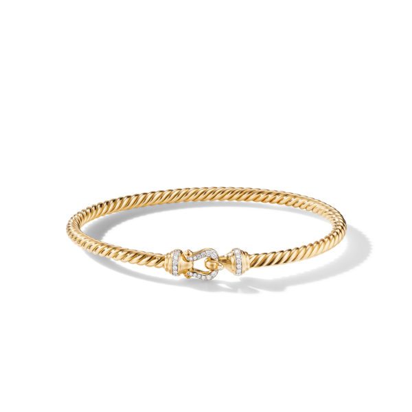 A gold twisted rope bracelet featuring a diamond-encrusted clasp. The bracelet has a sleek and elegant design, with the diamonds adding a touch of sparkle and sophistication. The bracelet is displayed on a plain white background.