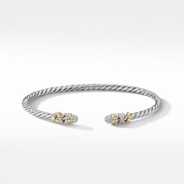 A silver twisted cable bracelet with gold accents and encrusted with diamonds at the open ends, displayed on a white background.