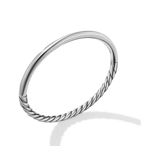 A sleek, minimalist silver bracelet with a twisted rope design on one half and a smooth, polished finish on the other half. The bracelet has a hinge for convenient wearing. The image casts a subtle shadow on a white background, highlighting the craftsmanship.