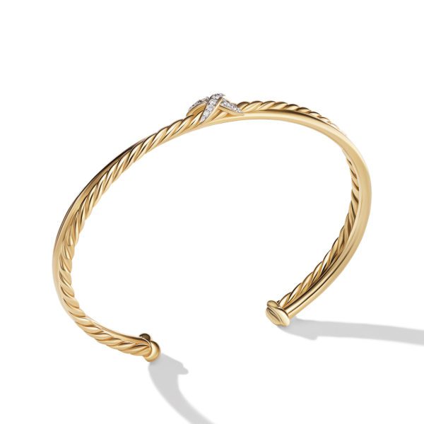 A gold twisted rope-style bangle with an open end, adorned with a small diamond-studded knot at the center. The bracelet casts a faint shadow on a white background.