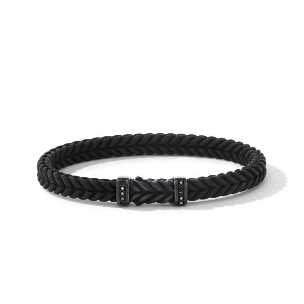 A sleek black braided bracelet with a magnetic clasp adorned with small, dark decorative accents. The bracelet has a minimalist yet elegant design, lying in a circular shape on a white surface.