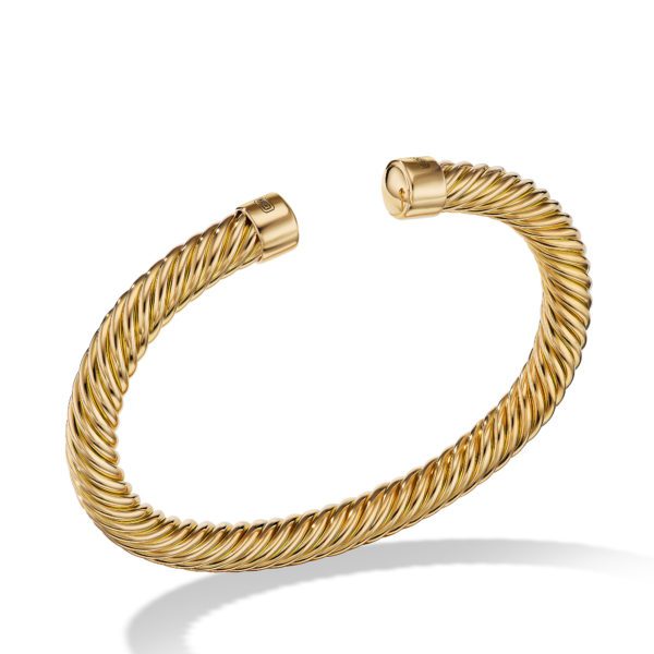 A gold twisted rope cuff bracelet with two open ends is displayed against a white background. The bracelet features intricate rope-like detailing, giving it a textured and elegant appearance.