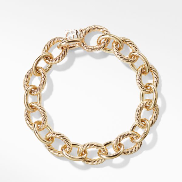 A close-up view of a gold chain bracelet with interlocking, twisted rope-style links. The bracelet is arranged in a circular shape against a white background, highlighting the intricate detailing and polished finish of the gold links.