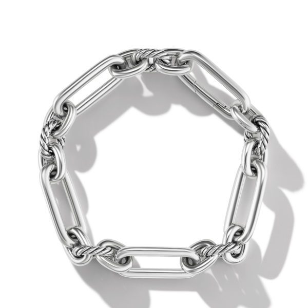 A silver chain bracelet composed of large, elongated oval links interspersed with twisted, rope-like connectors, arranged in a circular form against a white background. The bracelet's shiny surface casts soft shadows.