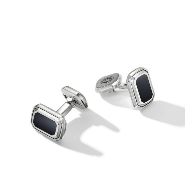 A pair of silver rectangular cufflinks featuring black inlays. The cufflinks have a polished finish with beveled edges and a classic, elegant design. The shadows cast by the cufflinks suggest they are placed on a white surface with lighting coming from the left side.