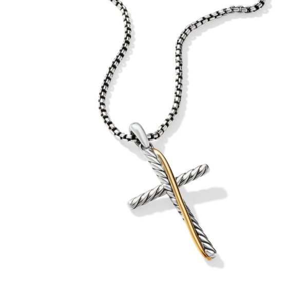 A cross-shaped pendant made of twisted silver with a gold accent line hangs from a silver beaded chain. The background is white.