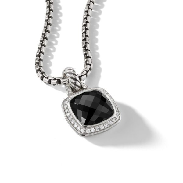 A close-up of a silver chain necklace with a square-shaped pendant. The pendant features a large, faceted black gemstone surrounded by a border of small, sparkling clear stones. The image is set against a plain white background.