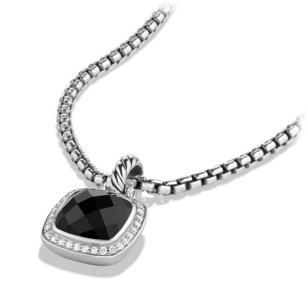 A silver necklace with a black gemstone pendant. The pendant is square-shaped with rounded corners, featuring a faceted black stone surrounded by a border of small, sparkling white stones. The chain is a sleek, looped design with a polished finish.