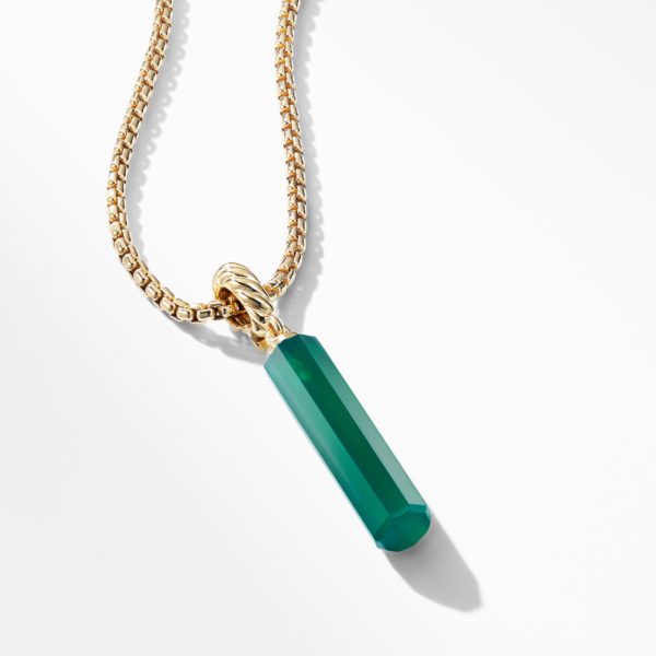 A close-up image of a gold chain necklace featuring a pendant with a green, faceted, rectangular gemstone. The pendant is attached to the chain by a twisted gold loop, and the necklace is displayed against a white background.