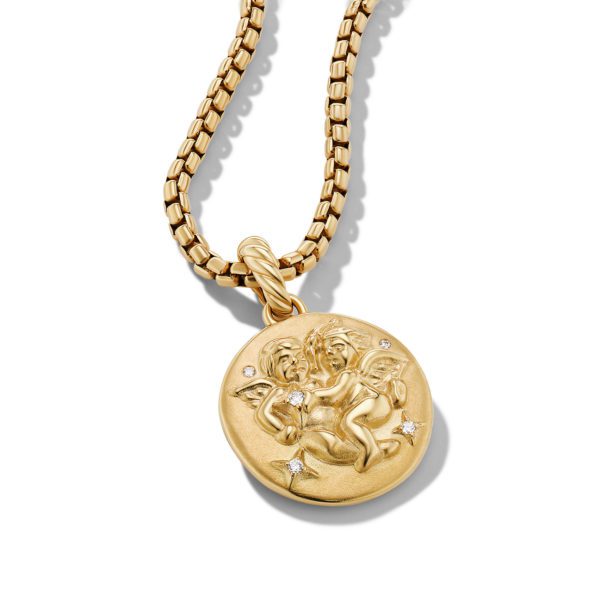 A gold chain necklace with a round pendant featuring an embossed design of two cherubs. The pendant is adorned with small, sparkling gemstones. The chain has a thick, box-like link pattern. The image is set against a plain white background.