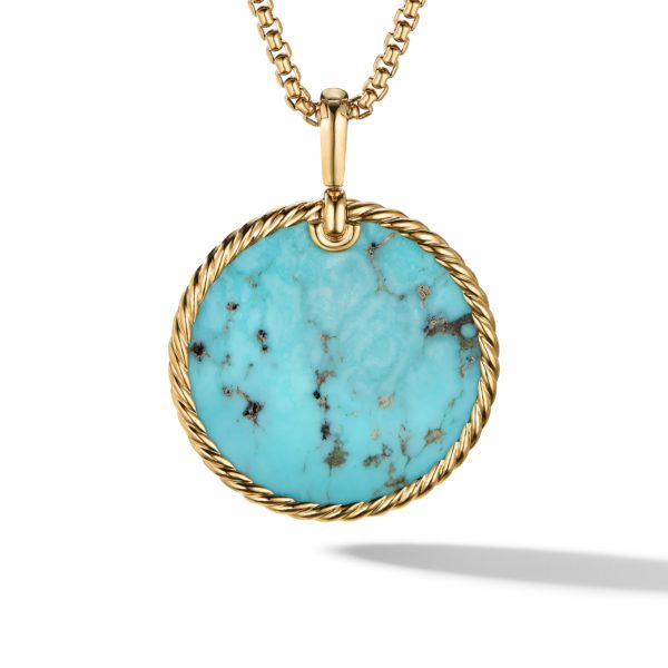 A gold pendant necklace featuring a round turquoise stone with dark veining. The stone is encircled by a twisted gold rope design, hanging from a gold chain. The high-polish finish reflects light, creating a shadow beneath the pendant.