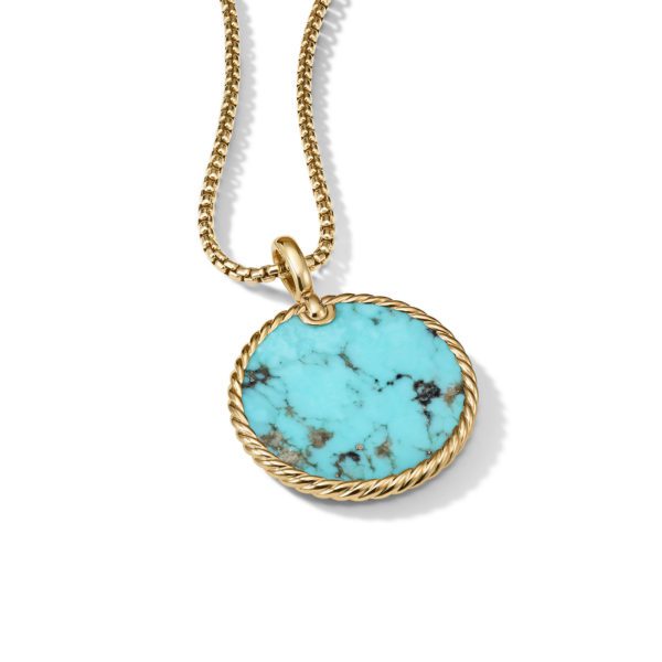 A gold chain necklace features a round turquoise pendant with marbled patterns. The turquoise pendant is encircled by a twisted gold rope design. The necklace is displayed on a plain white background.