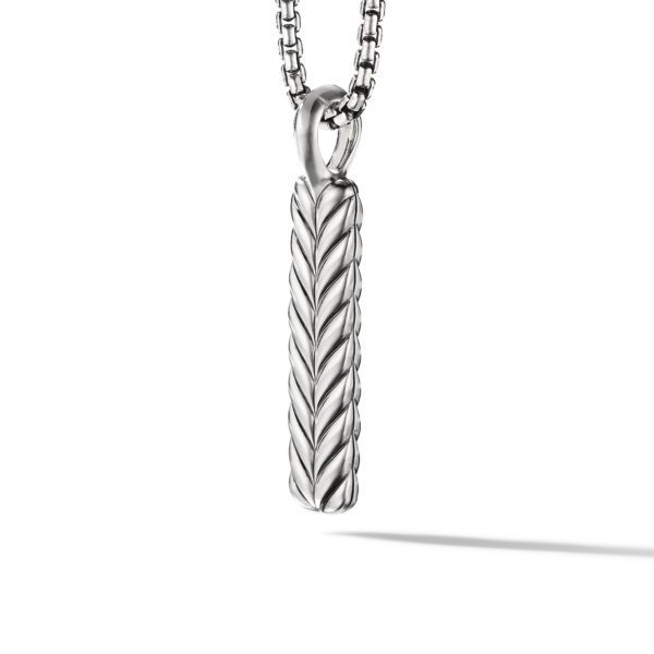 A silver necklace with a pendant featuring a cylindrical design resembling a braided pattern. The chain consists of interlocking circular links. The pendant and chain are displayed against a white background, casting a subtle shadow.