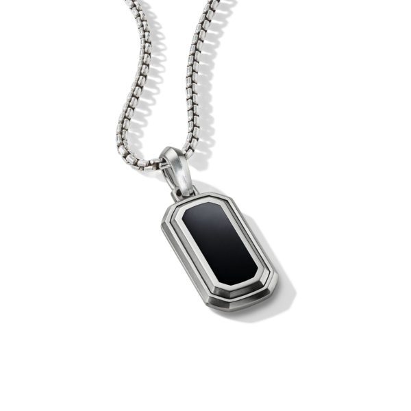 A rectangular silver pendant with a black center hangs from a silver chain. The pendant has beveled edges and a polished finish, giving it a sleek and modern look, showcased against a white background.