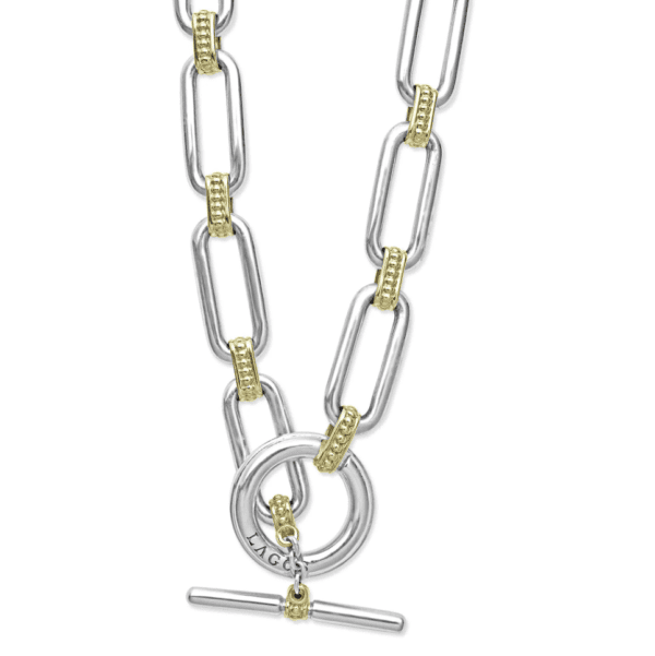 Close-up of the LAGOS Signature Caviar Two Tone Link Necklace showcasing elongated rectangular silver links intertwined with smaller gold accents. It features a toggle clasp with a round loop and bar, complete with an engraved tag visible on the loop.