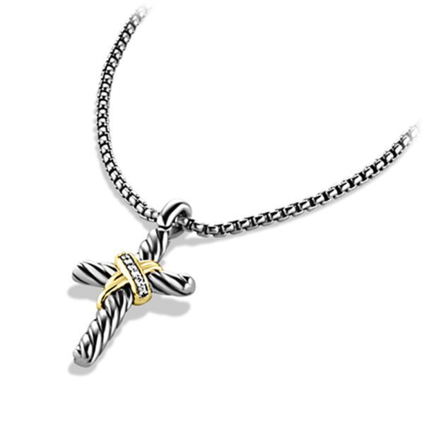 A silver necklace features a twisted rope design cross pendant with a small gold accent and a few tiny embedded diamonds or clear stones. The pendant hangs from a polished, finely detailed chain.