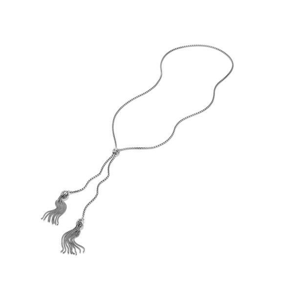 A long, silver lariat necklace with two chain tassel ends. The necklace features a thin, delicate chain that loops through a knot, allowing the tassel ends to dangle freely. The tassels are composed of multiple small chains gathered together.