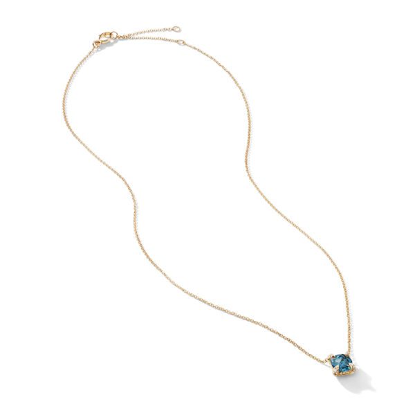 A delicate gold chain necklace with a round blue gemstone pendant, shown against a white background. The pendant hangs from the center of the chain, which is unclasped and laid out in a looped shape.