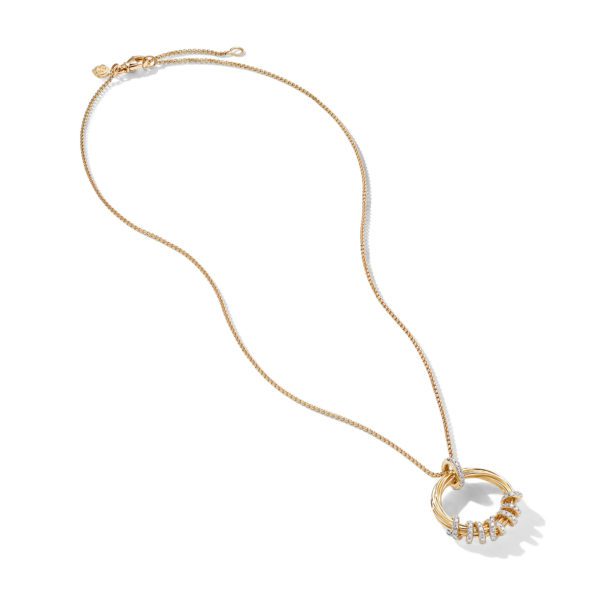 A gold necklace with a delicate chain and a circular pendant. The pendant consists of a series of smaller interlocking rings, some adorned with small, sparkling gemstones. The necklace is laid out against a plain white background.