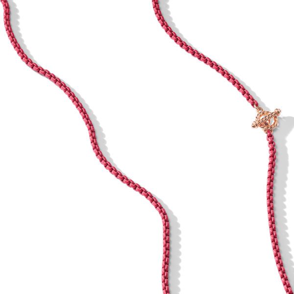 A red braided rope-like object with a decorative gold knot tied near one end, photographed on a white background.