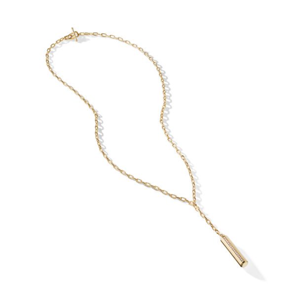 A delicate gold chain necklace with a pendant featuring a vertical bar adorned with small embedded stones. The chain has an elegant, slightly twisted design and is arranged in a loose, flowing shape on a white background.