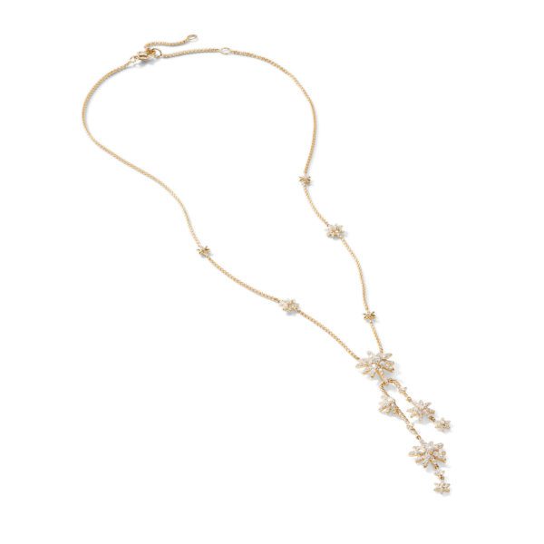 A gold chain necklace featuring a delicate design with sparkling star-shaped charms and floral motifs hanging from the chain. The necklace has an adjustable clasp for varying lengths. The design gives it an elegant and sophisticated appearance.