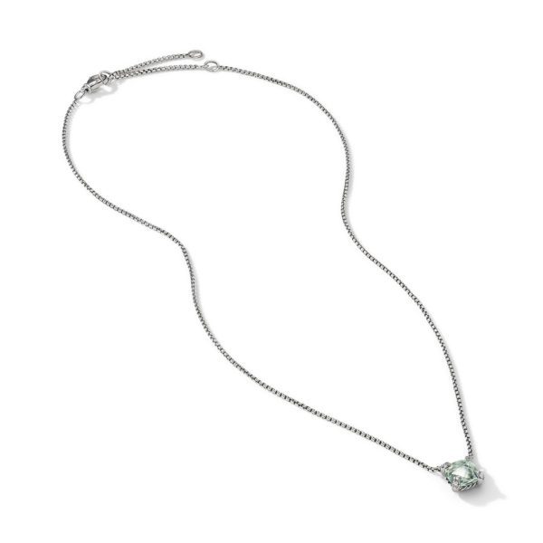 A delicate silver necklace featuring a small, elegant pendant adorned with a light green gemstone. The necklace has a fine chain and an adjustable clasp for varied lengths. The pendant is in the center, catching light to highlight its color and sparkle.