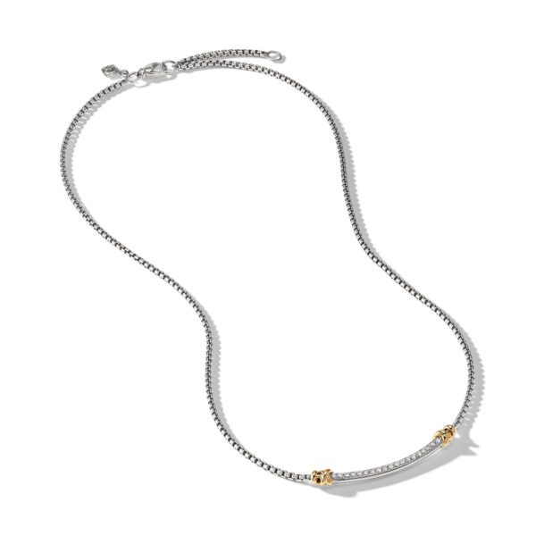 A silver necklace with a thin, curved bar adorned with small diamonds at its center. It features two gold accents on either side of the bar and is connected by a delicate chain with an adjustable clasp. The necklace is displayed on a plain white background.